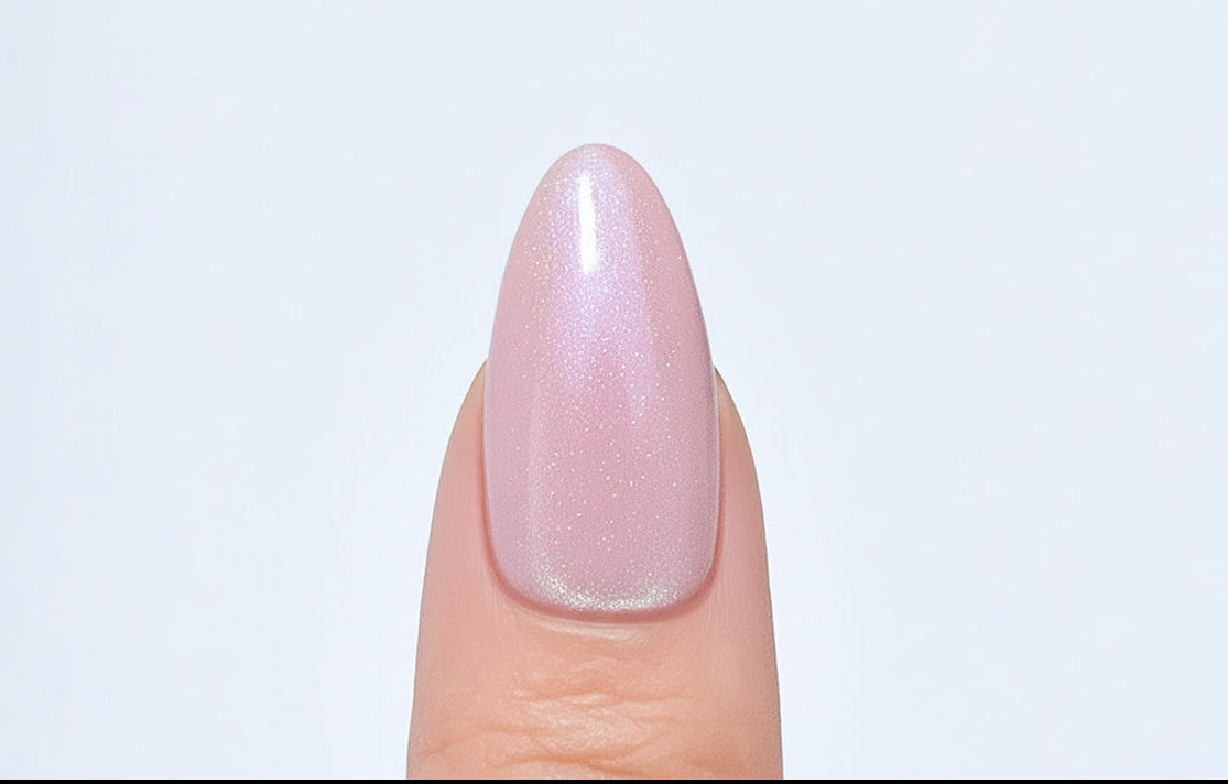 Nail with pinkish-purple polish on a light gray background